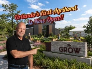 Farmhouse-style building at The Grow agrihood community in East Orlando with working farm and gardens visible